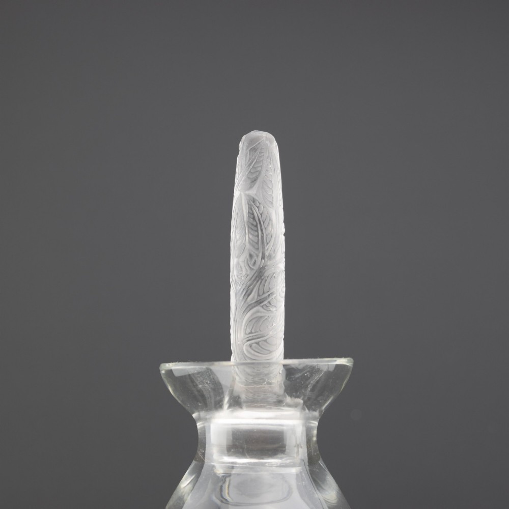 A pair of clear glass Art Deco conical decanters featuring elongated frosted glass stoppers with delicate leaf motifs. View IV