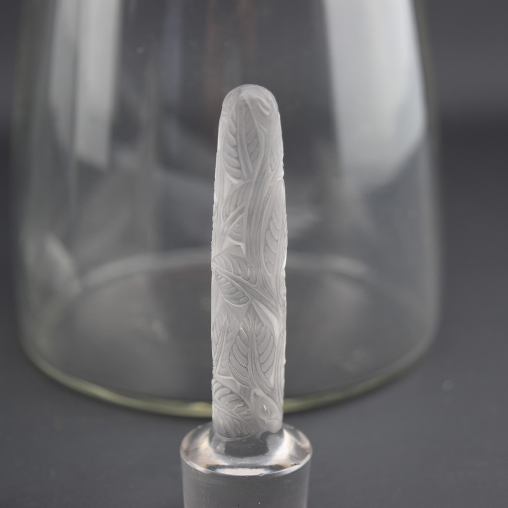 A pair of clear glass Art Deco conical decanters featuring elongated frosted glass stoppers with delicate leaf motifs. View VII