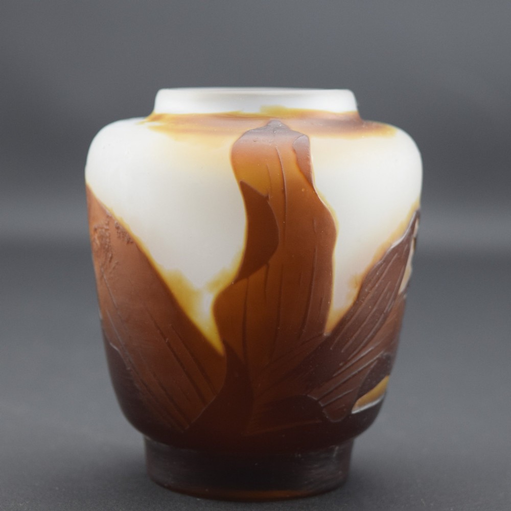 A small Art Nouveau cameo glass vase featuring brown acid-etched floral motifs over a frosted white background. View IV