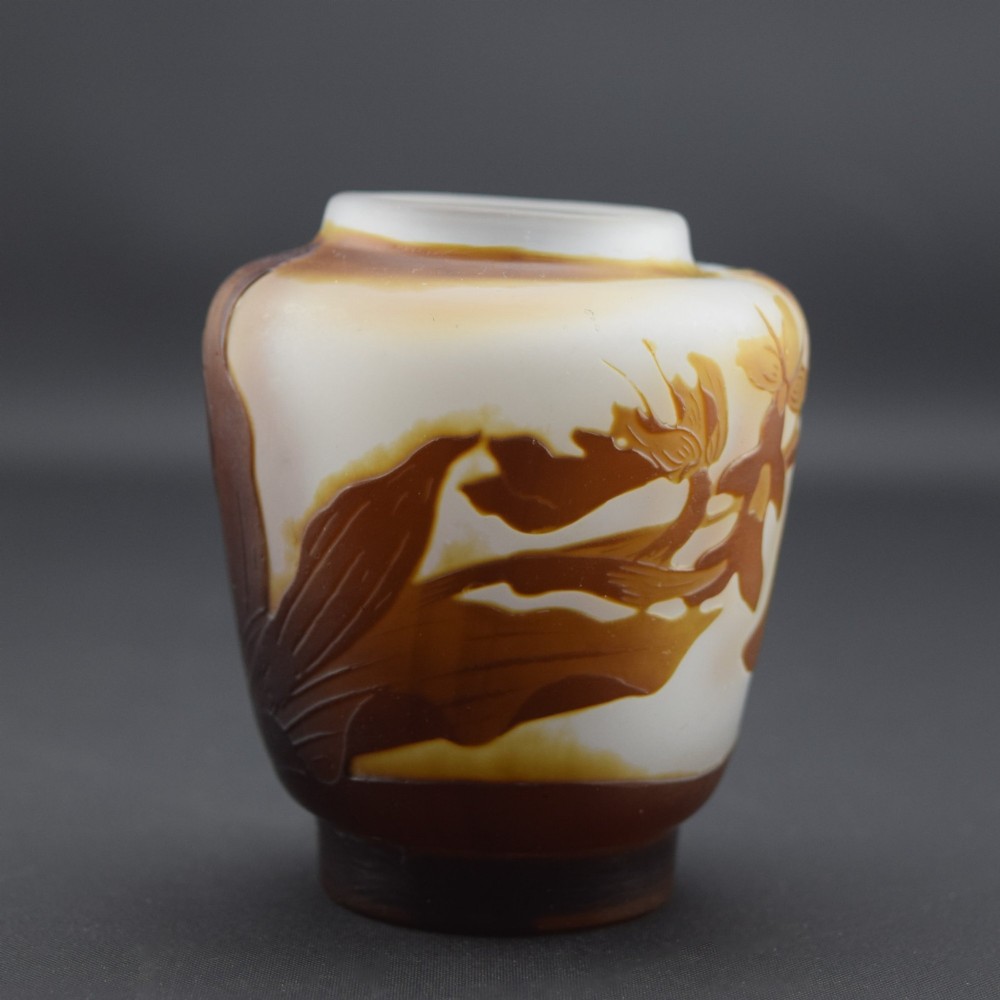 A small Art Nouveau cameo glass vase featuring brown acid-etched floral motifs over a frosted white background. View V