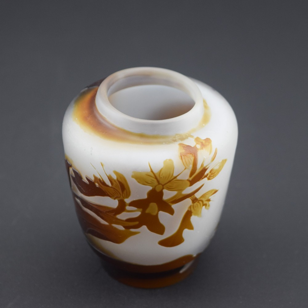 A small Art Nouveau cameo glass vase featuring brown acid-etched floral motifs over a frosted white background. View VIII