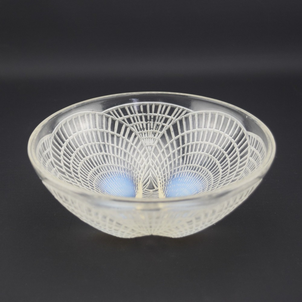 An overhead view of a circular Rene Lalique Art Deco opalescent glass bowl featuring four sculpted seashell motifs that converge at the centre. View III
