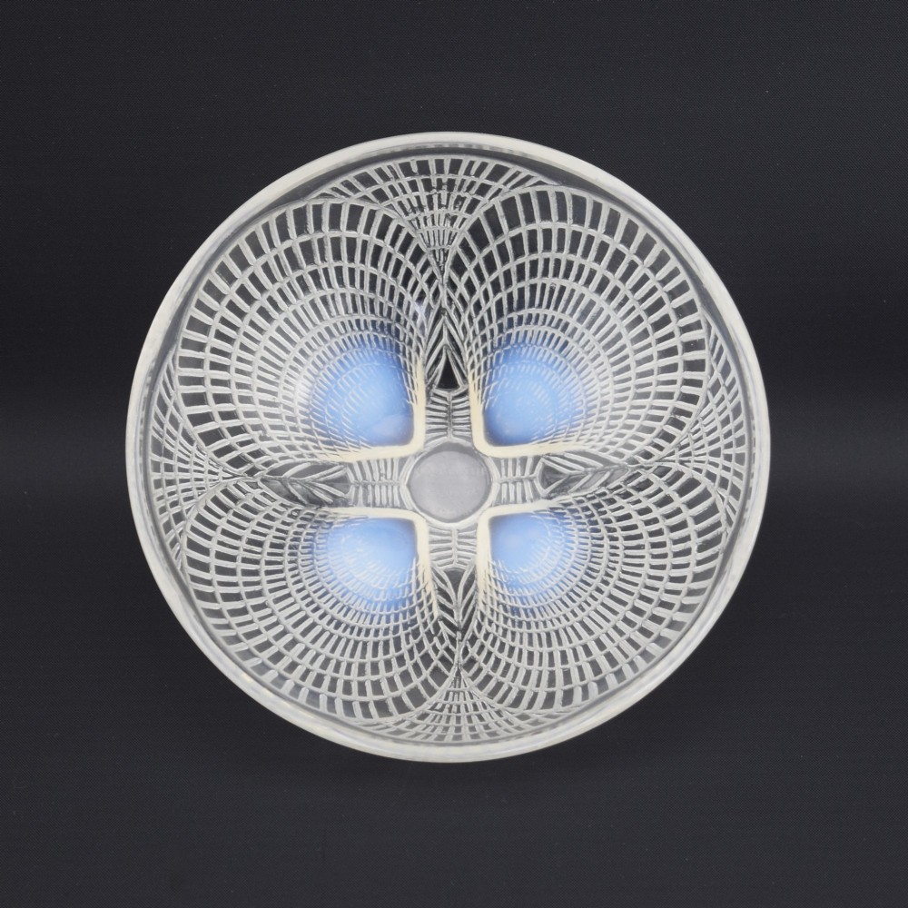 An overhead view of a circular Rene Lalique Art Deco opalescent glass bowl featuring four sculpted seashell motifs that converge at the centre. View V