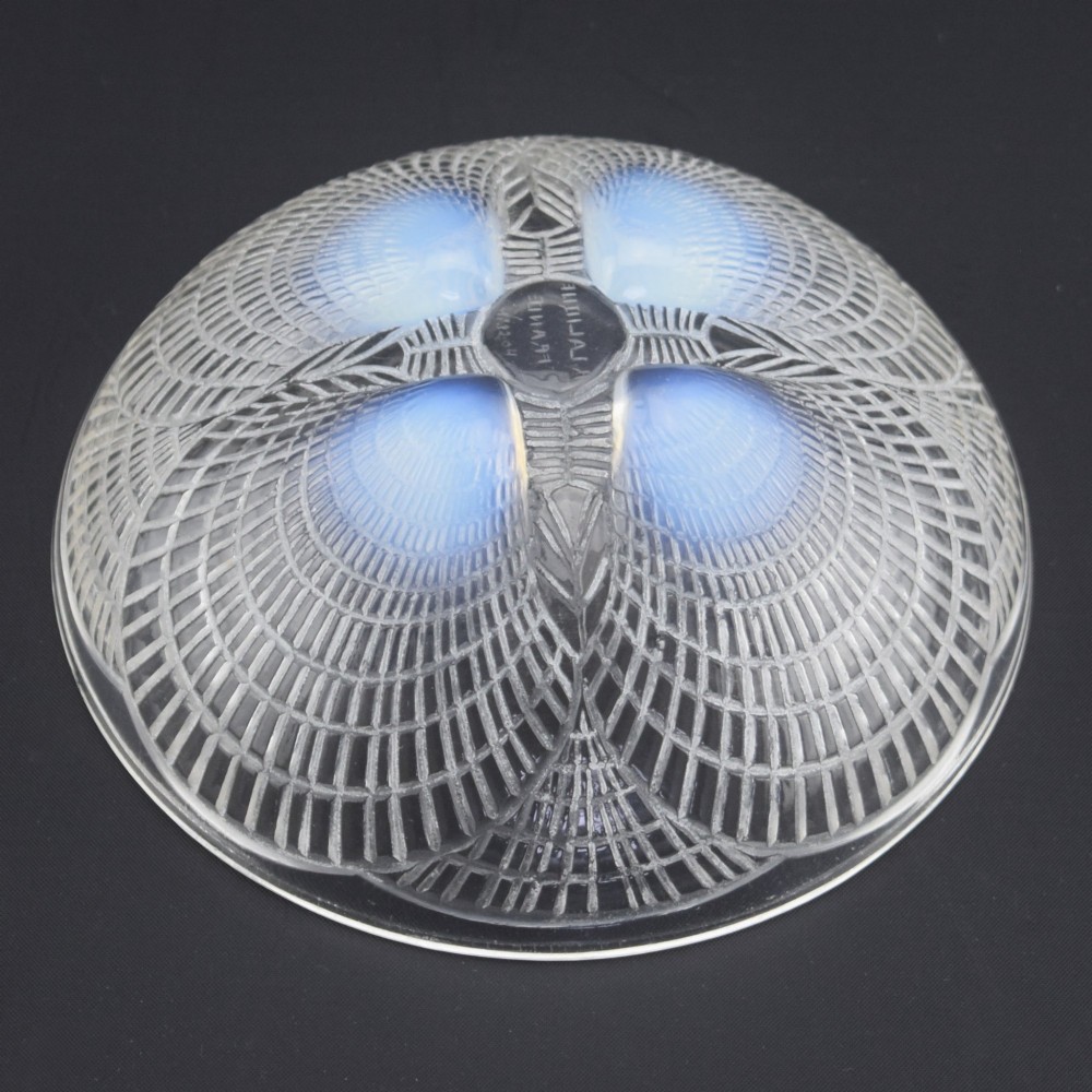 An overhead view of a circular Rene Lalique Art Deco opalescent glass bowl featuring four sculpted seashell motifs that converge at the centre. View VI
