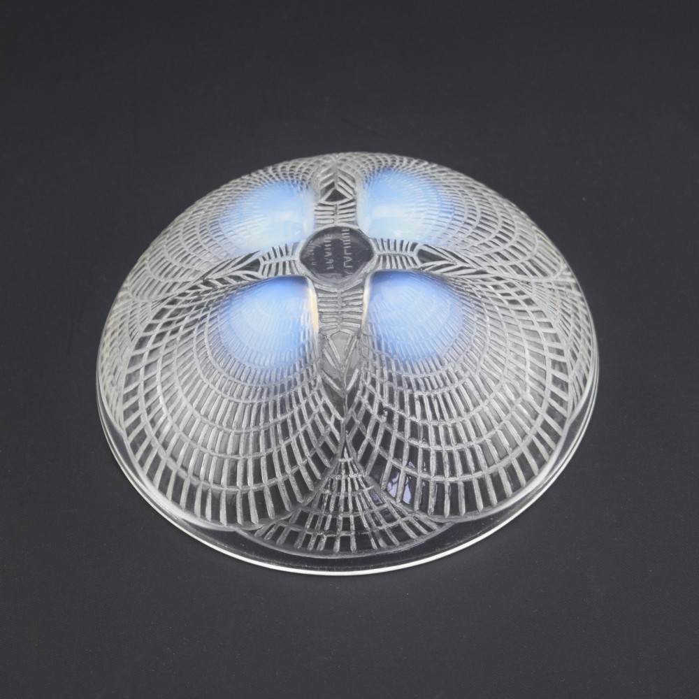 An overhead view of a circular Rene Lalique Art Deco opalescent glass bowl featuring four sculpted seashell motifs that converge at the centre. View VII