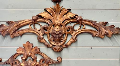 fig 1. A set of three carved gold giltwood wall fragments decorated with central mascaron faces and scrolling acanthus leaves.