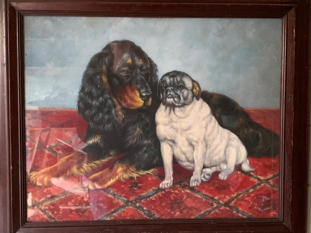 An oil painting on wooden panel depicting a black and tan spaniel resting next to a pug on a red patterned carpet inside a dark wooden frame.