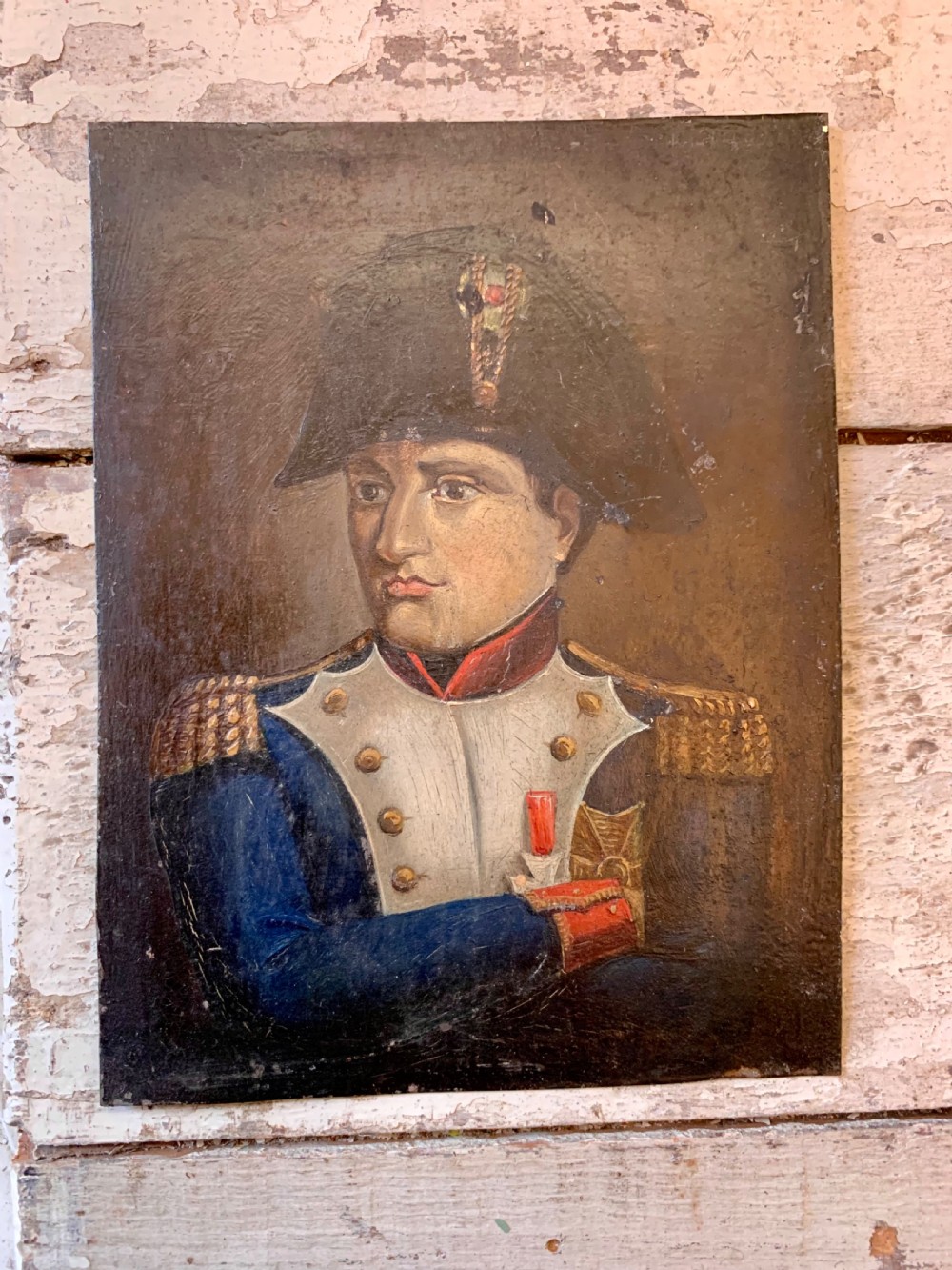 A 19th-century miniature oil portrait depicting Napoleon Bonaparte in a blue military uniform and black bicorne hat against a dark background. View III