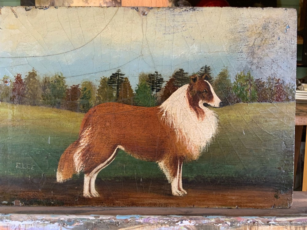 An English Naive School oil painting on board depicting a brown and white collie standing in profile against a grassy landscape with trees.