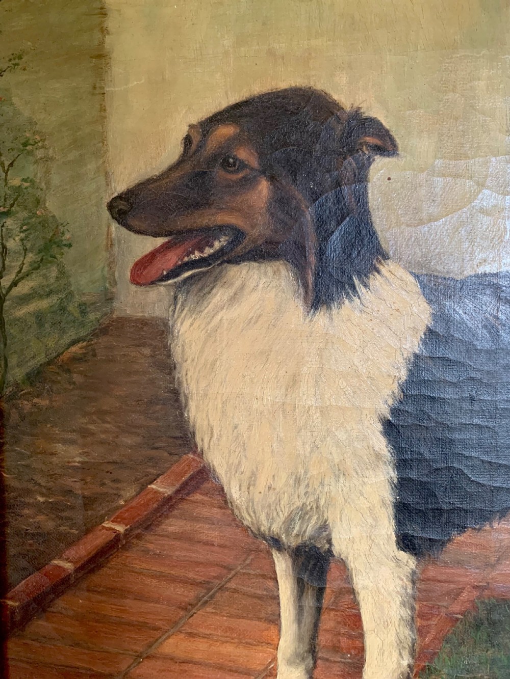 An antique oil painting depicting a black and white dog standing in a paved courtyard, encased in an ornate gold leaf frame. View IV