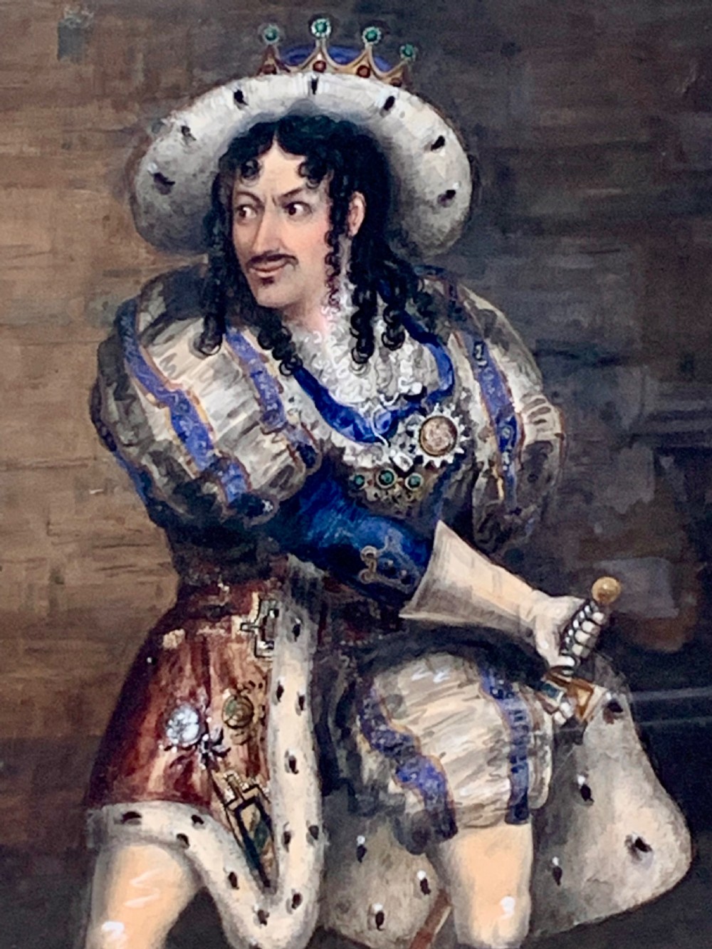 A framed watercolour portrait depicting a male figure in historical cavalier costume within a stone interior, encased in a gold moulded frame. View IV