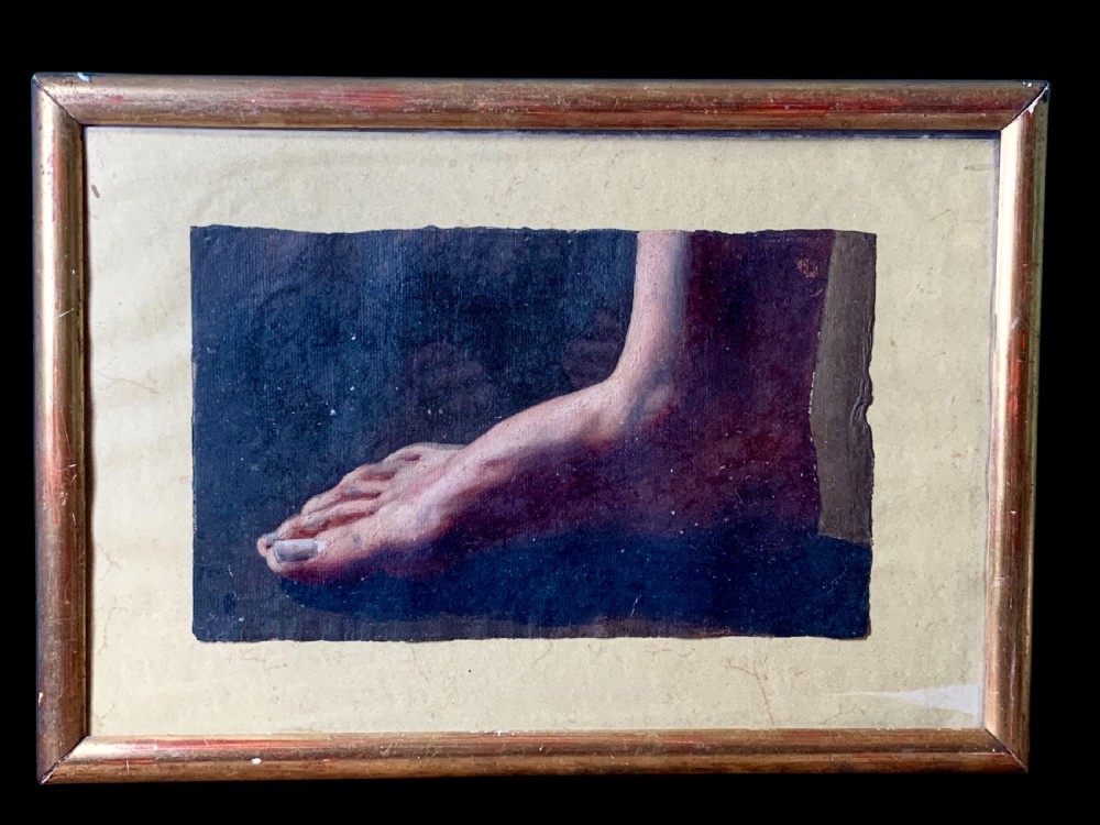 An early 19th-century academic oil study depicting a human foot rendered on paper, presented within a slender gilded wooden frame. View III