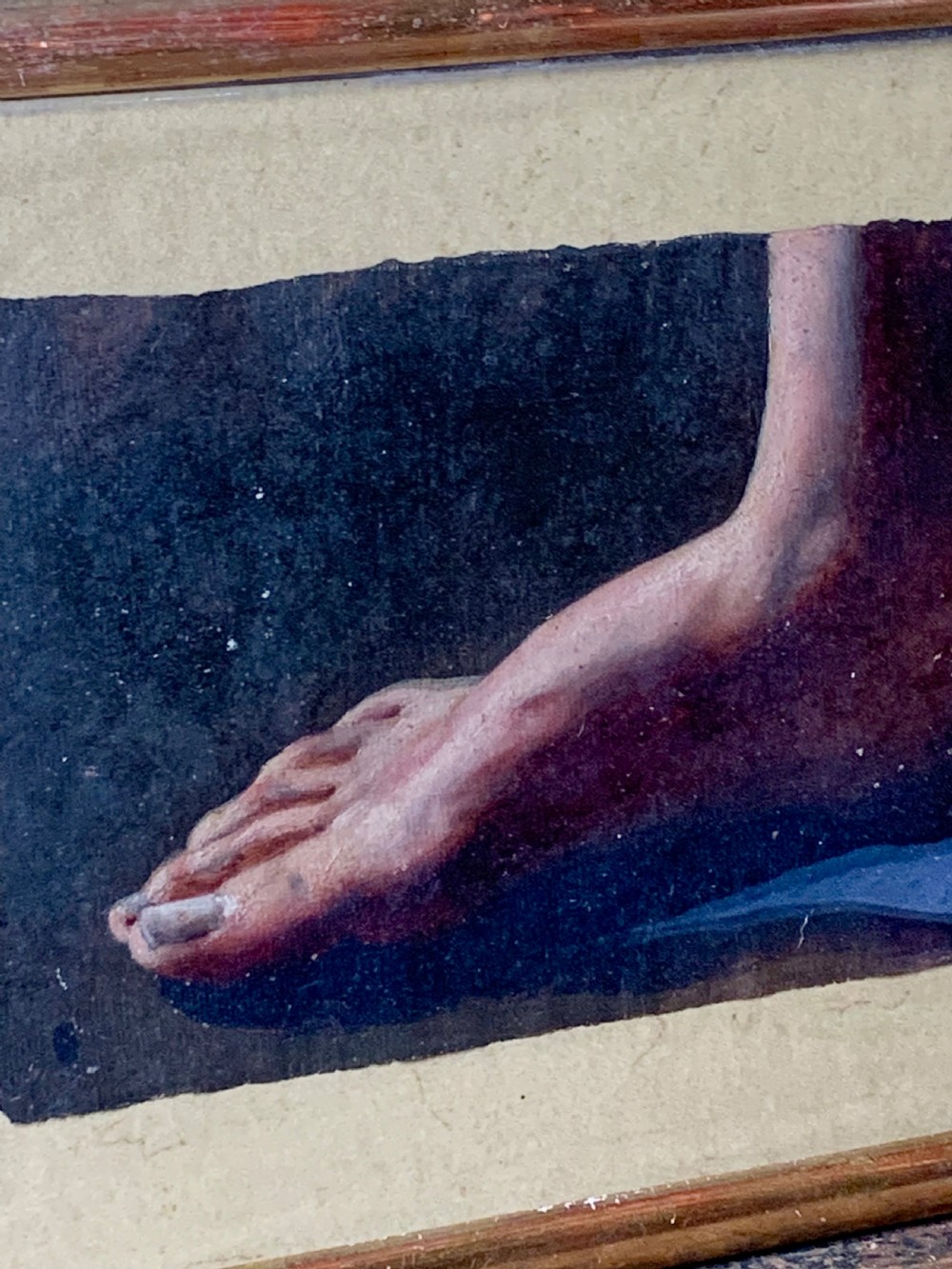 An early 19th-century academic oil study depicting a human foot rendered on paper, presented within a slender gilded wooden frame. View IV
