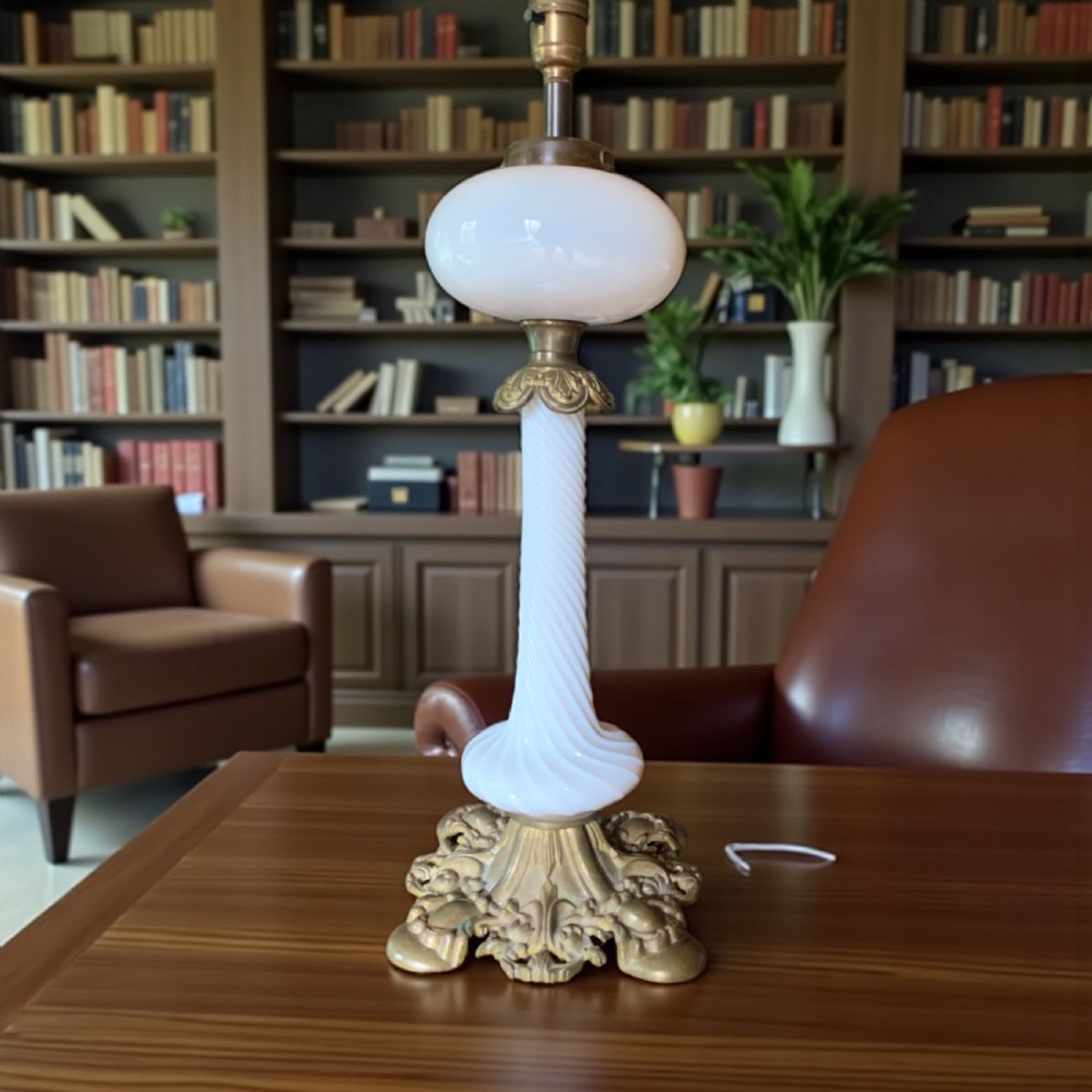 A 19th-century Victorian table lamp featuring a white fluted opaline glass column set on an ornate cast bronze base.
