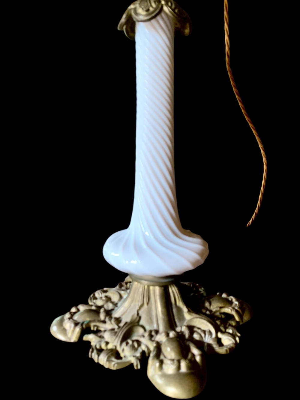 A 19th-century Victorian table lamp featuring a white fluted opaline glass column set on an ornate cast bronze base. View IV