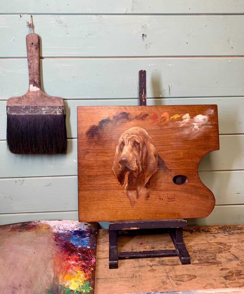 A 19th CENTURY OIL PORTRAIT OF A BLOODHOUND ON ARTIST’S PALETTE