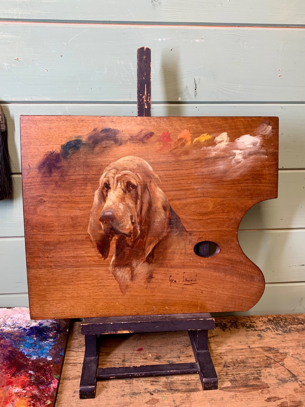 A nineteenth-century oil painting depicting the head of a bloodhound executed directly onto a wooden artists palette with paint swatches visible along the upper edge. View II