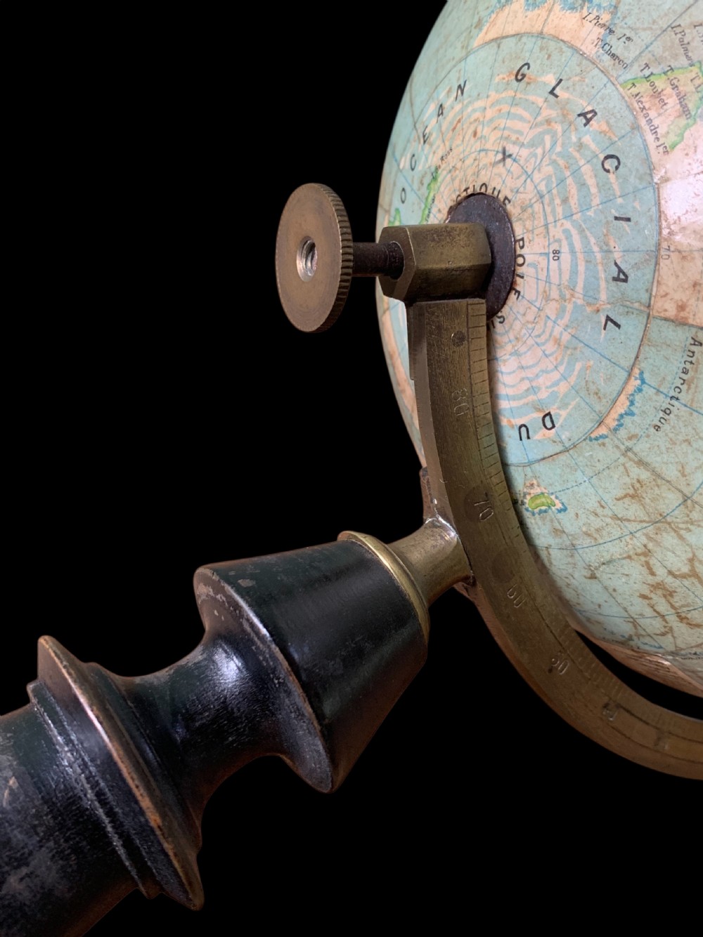 A vintage French terrestrial globe featuring cream paper map gores on a brass meridian half-ring and a turned dark wood pedestal base. View VI