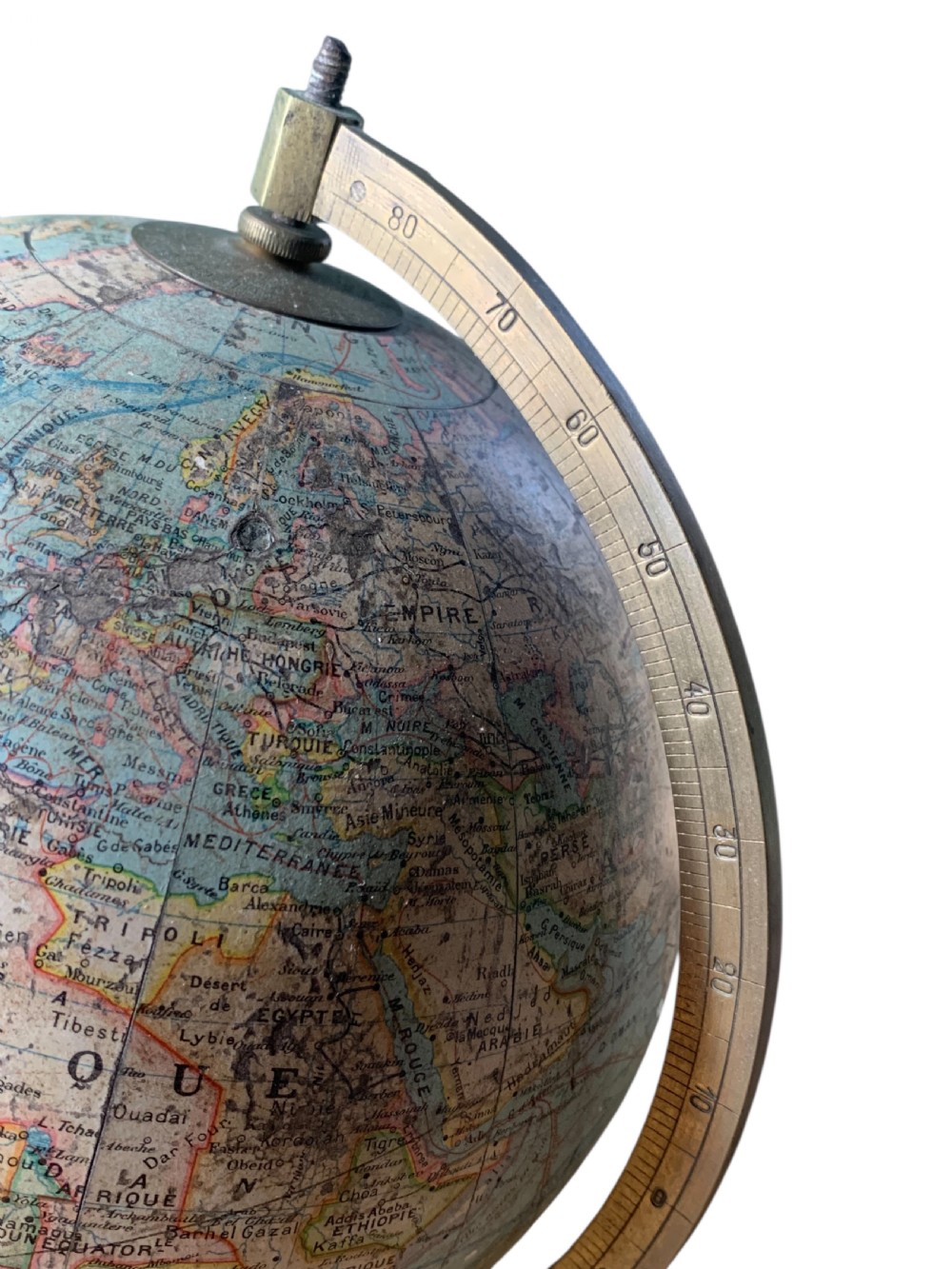 A vintage French terrestrial globe featuring cream paper map gores on a brass meridian half-ring and a turned dark wood pedestal base. View VIII