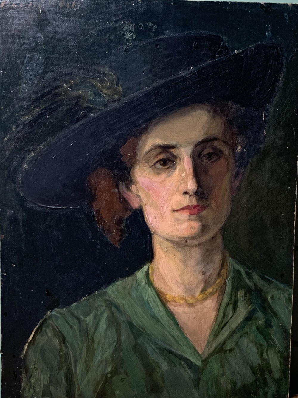 An oil painting on board depicting a woman wearing a wide-brimmed black hat with plumes, a green dress, and a yellow bead necklace against a dark background. View IV