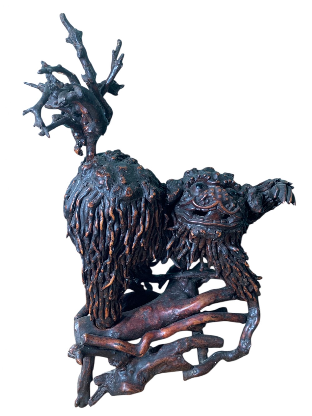 A pair of dark carved root wood Chinese guardian lion sculptures raised on organic natural root bases. View IV