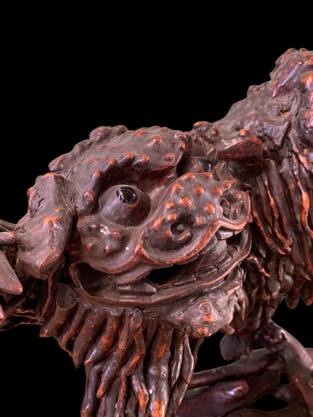 A pair of dark carved root wood Chinese guardian lion sculptures raised on organic natural root bases. View XIV