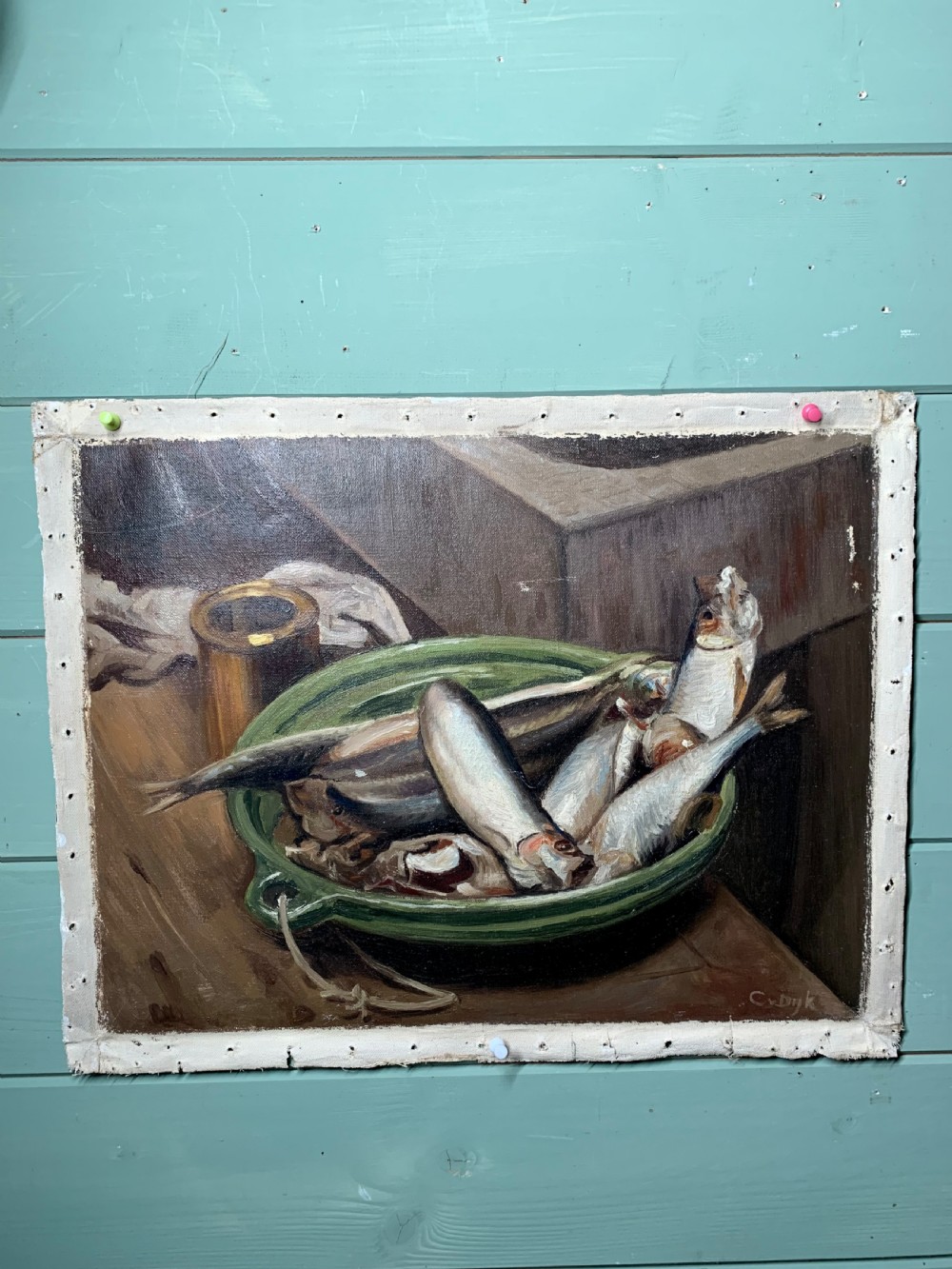 An unframed early 20th-century oil painting on canvas depicting a green ceramic basin filled with fish alongside a brass vessel on a wooden surface. View II