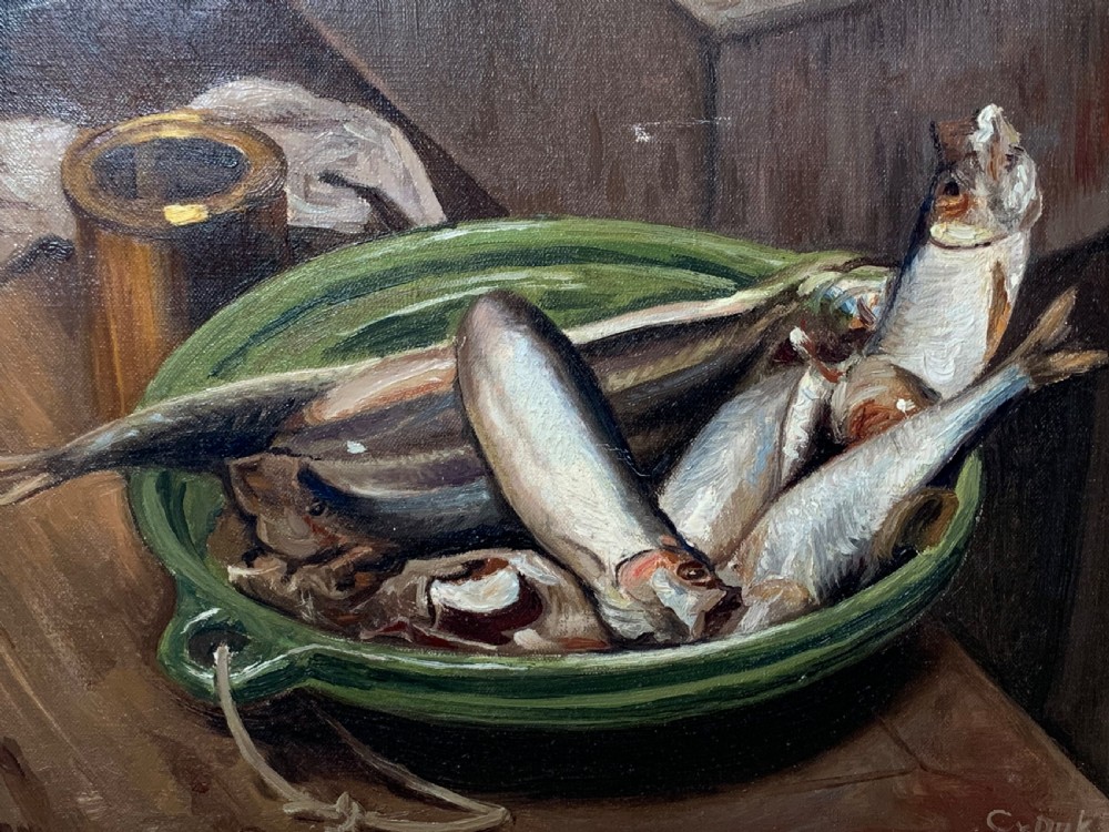 An unframed early 20th-century oil painting on canvas depicting a green ceramic basin filled with fish alongside a brass vessel on a wooden surface. View IV