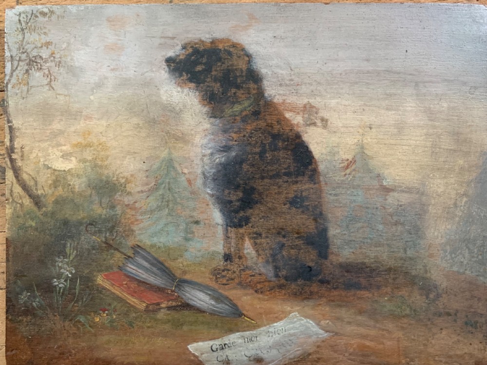 An antique Victorian oil painting on a wooden panel depicting a seated brown and white dog alongside a folded umbrella, a red book, and a paper note in a muted landscape. View V