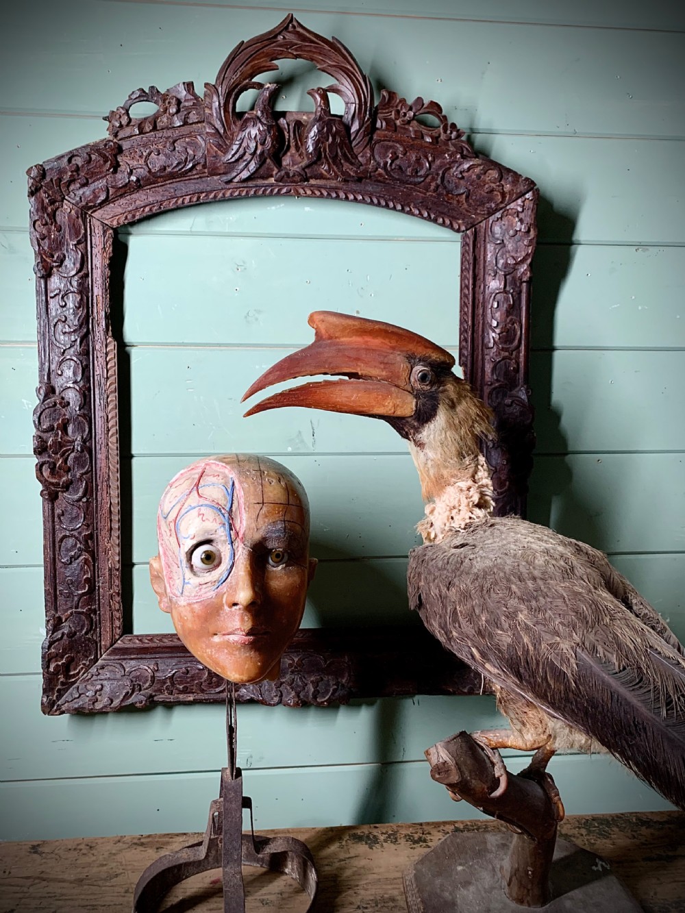 A life-size antique anatomical wax head displaying detailed vascular structures and grid markings, featuring inset glass eyes and mounted on a dark metal stand. View VIII