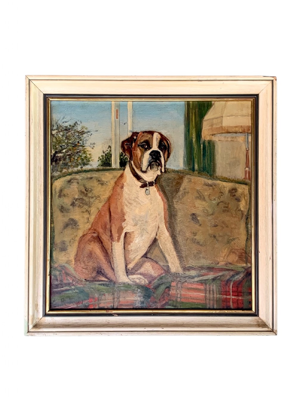 A framed oil painting on board depicting a brown and white Boxer dog seated indoors on a patterned sofa.