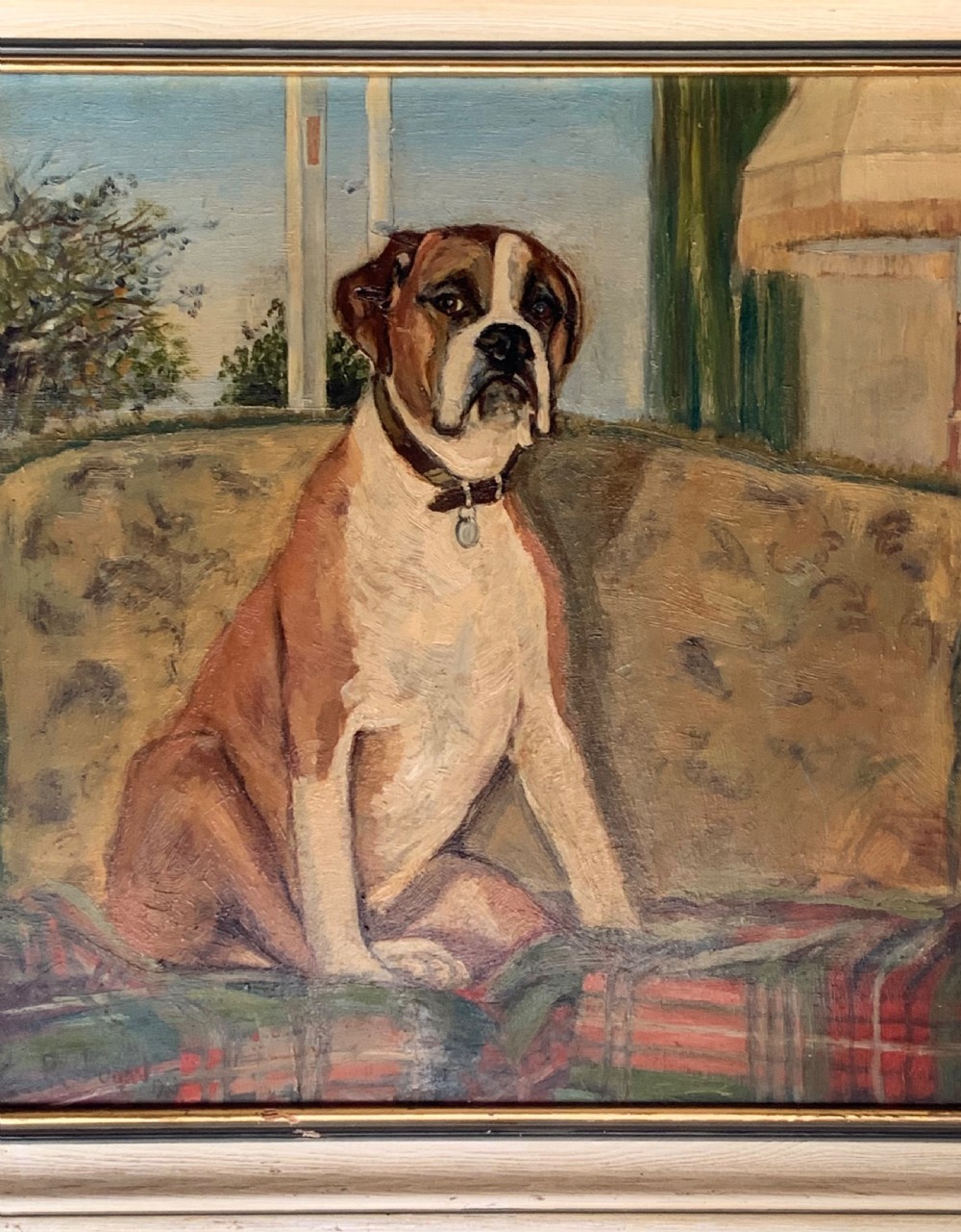 A framed oil painting on board depicting a brown and white Boxer dog seated indoors on a patterned sofa. View II