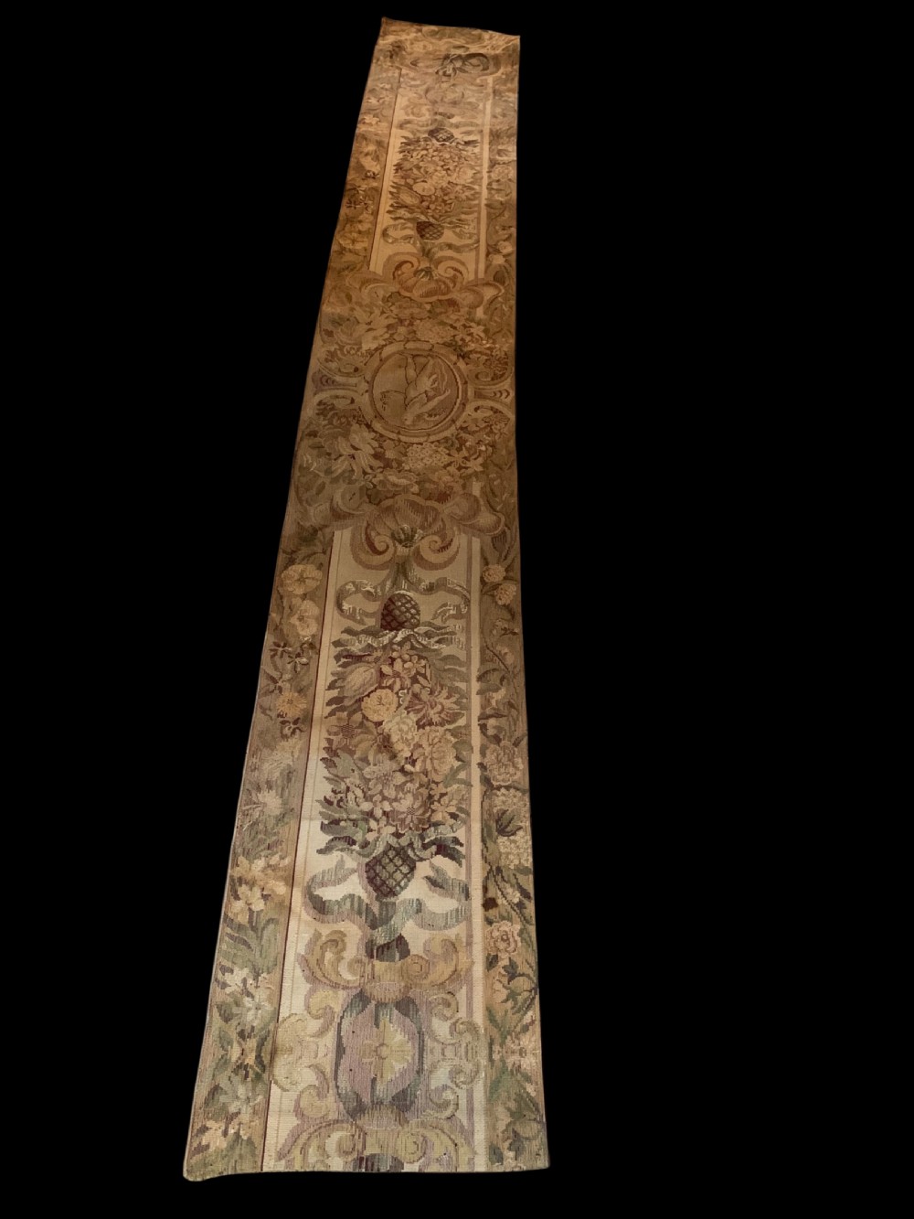 Three vertical woven French tapestry panels displaying floral garlands, urns, and foliate scrollwork in neutral beige, rose, and green tones. View II