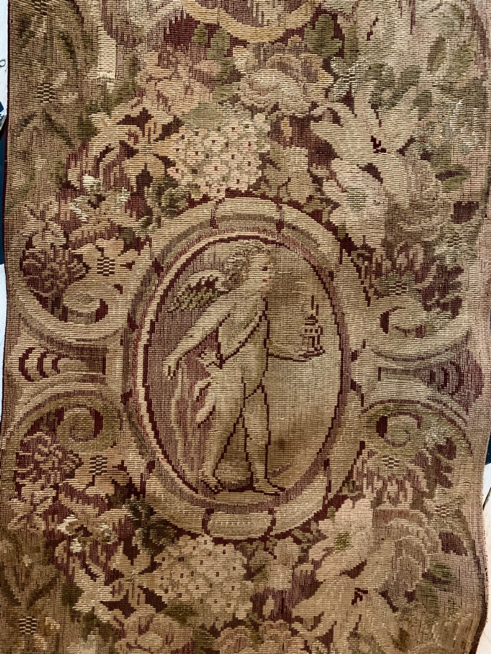 Three vertical woven French tapestry panels displaying floral garlands, urns, and foliate scrollwork in neutral beige, rose, and green tones. View VI
