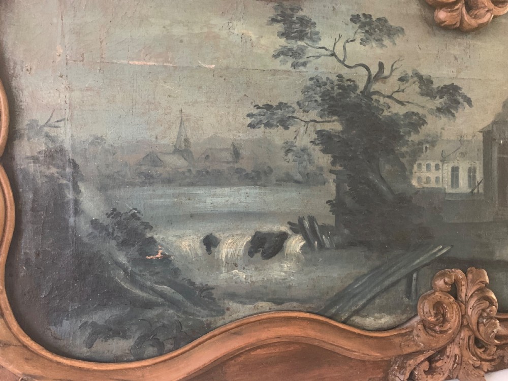 An 18th-century rectangular wooden overdoor panel featuring a carved serpentine border around a painted green landscape scene. View II