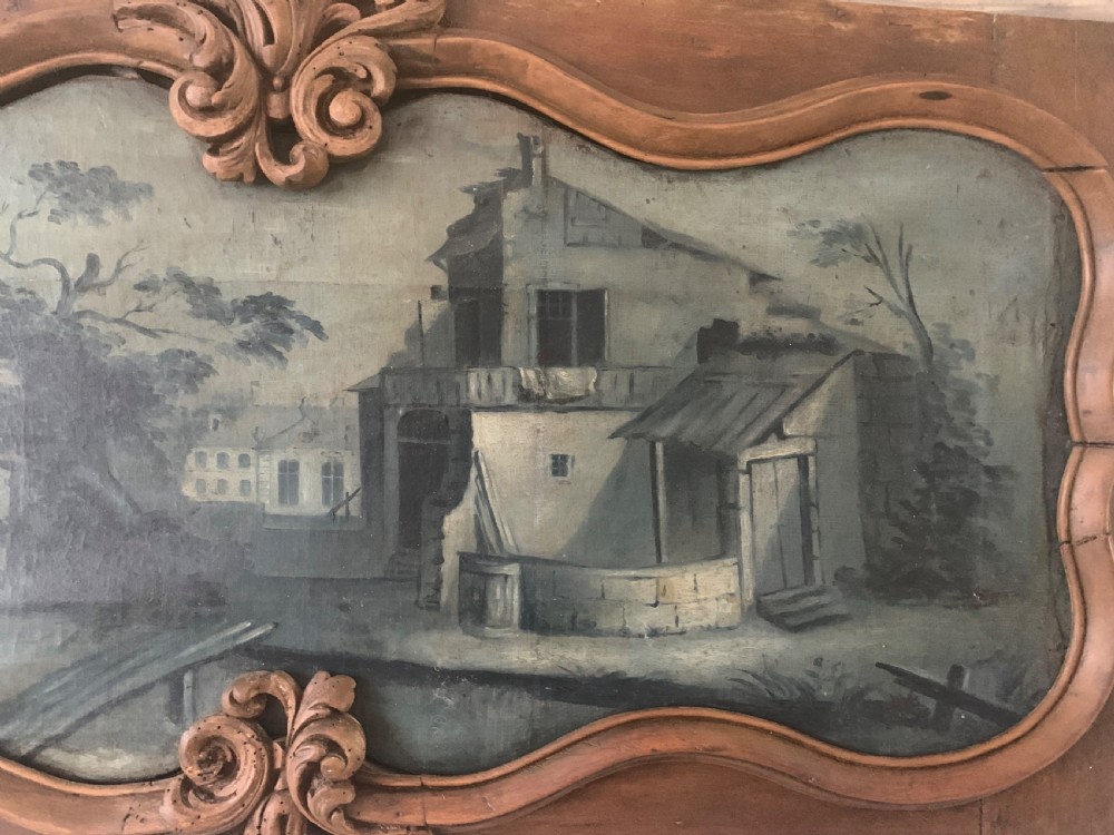 An 18th-century rectangular wooden overdoor panel featuring a carved serpentine border around a painted green landscape scene. View V