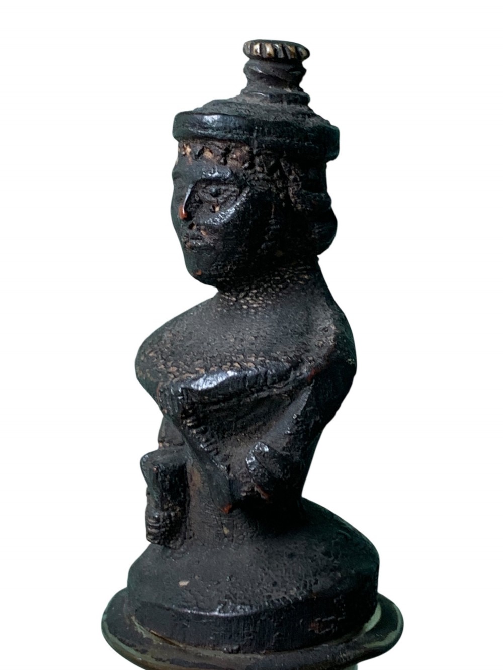 A clear glass bottle housing a detailed hand-carved bone miniature structure inside, topped with a cork and a dark carved bust finial stopper. View VI