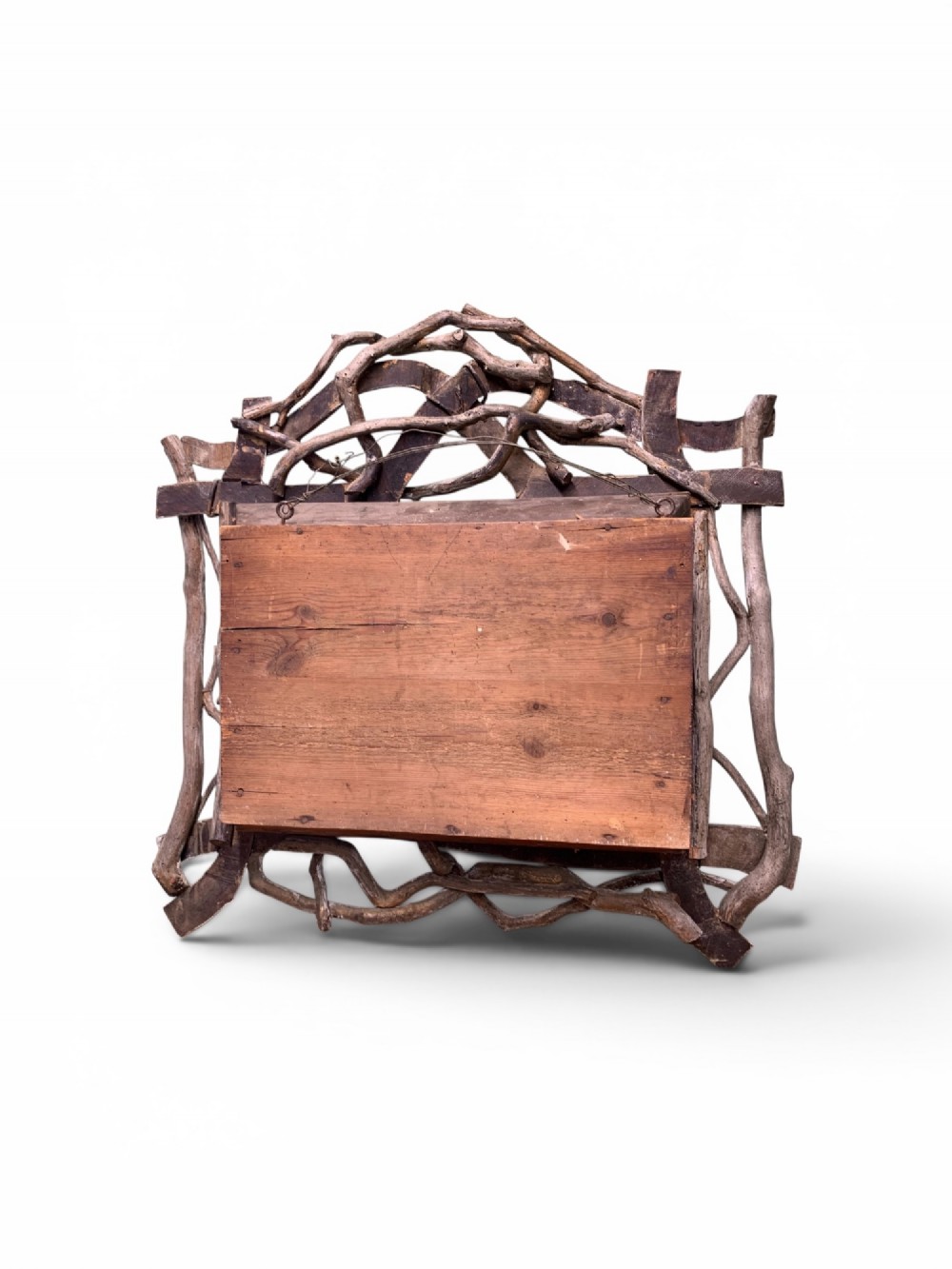 An antique three-dimensional cork diorama depicting a village church scene enclosed within a frame crafted from intertwined rustic twigs. View V