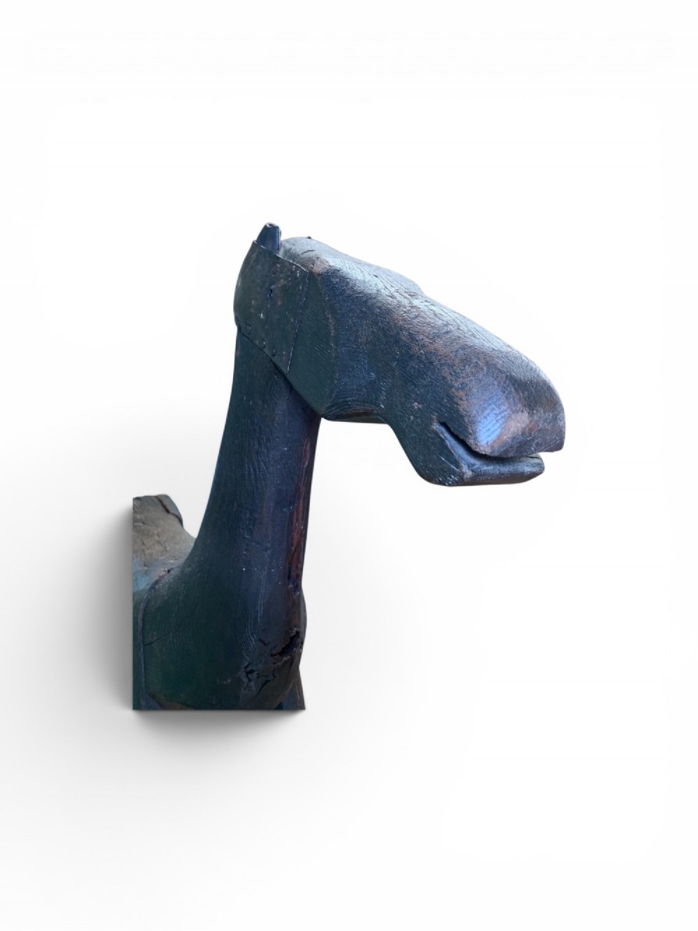 A naive hand-carved dark wood figure of a horse mounted on a flat wooden base with four simple circular wheels. View XIII