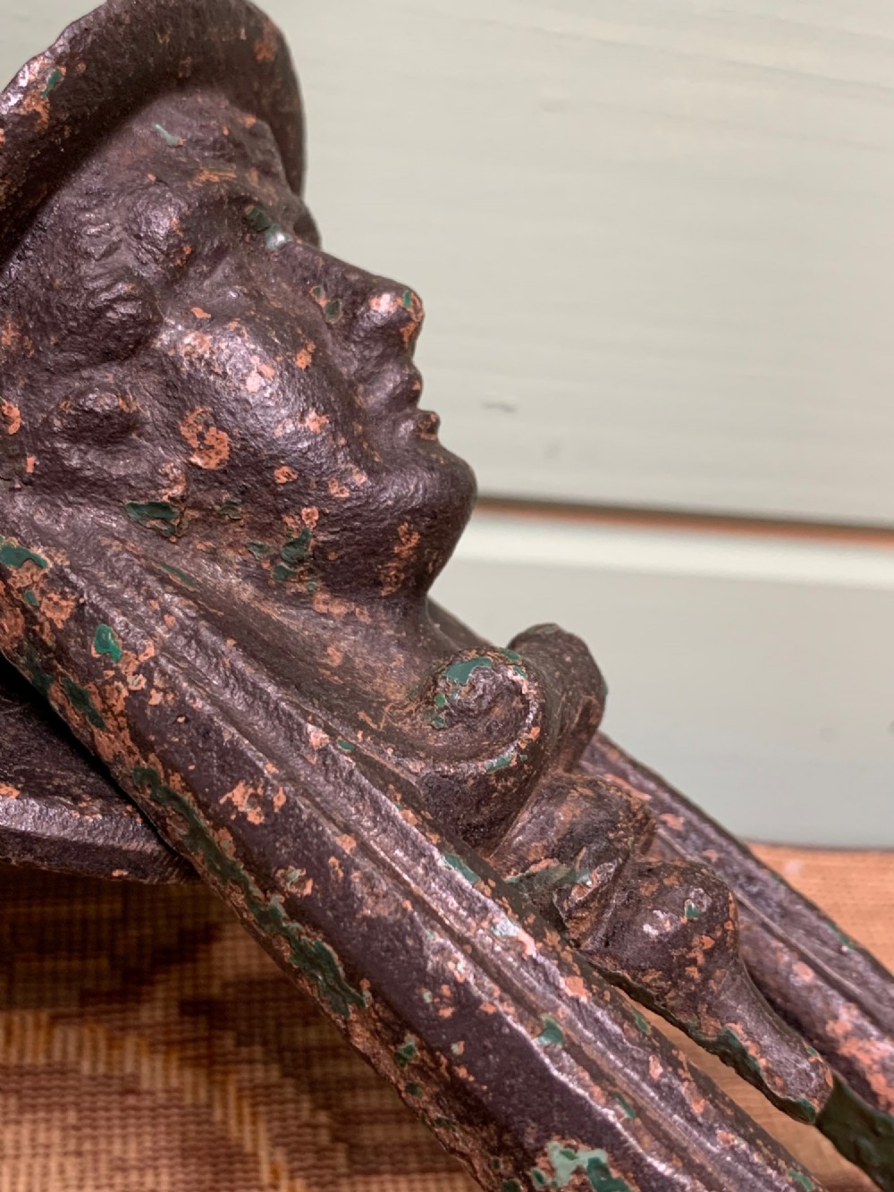 A Victorian cast iron door knocker featuring a sculpted classical Hermes head atop a drop-down loop striker. View IV