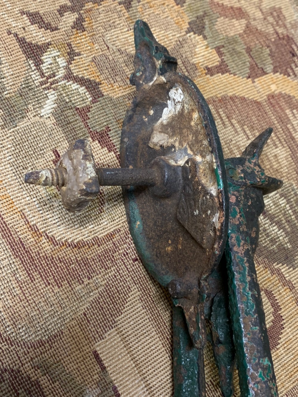 A Victorian cast iron door knocker featuring a sculpted classical Hermes head atop a drop-down loop striker. View VI