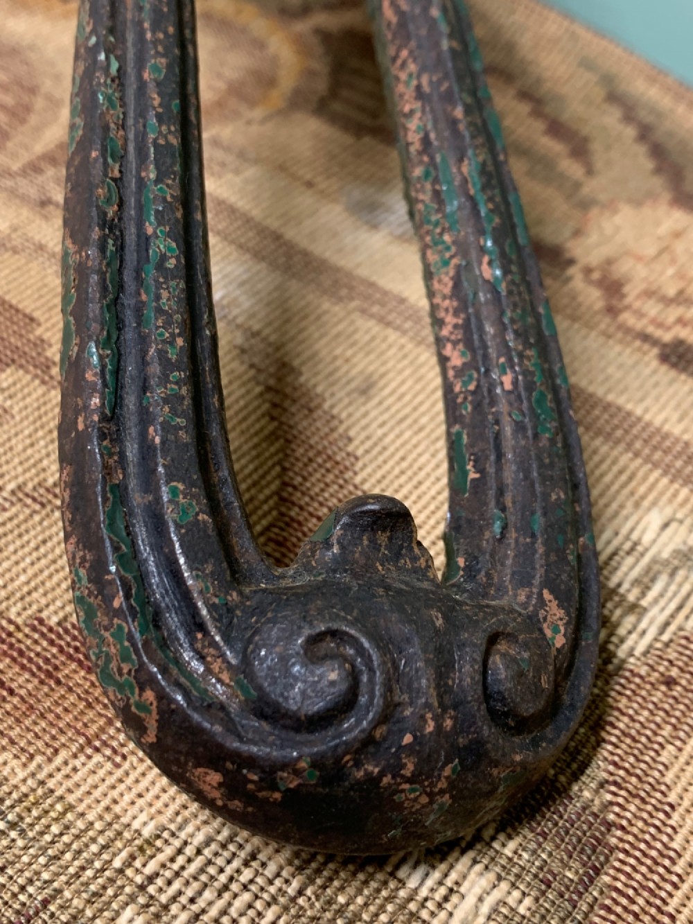 A Victorian cast iron door knocker featuring a sculpted classical Hermes head atop a drop-down loop striker. View VII
