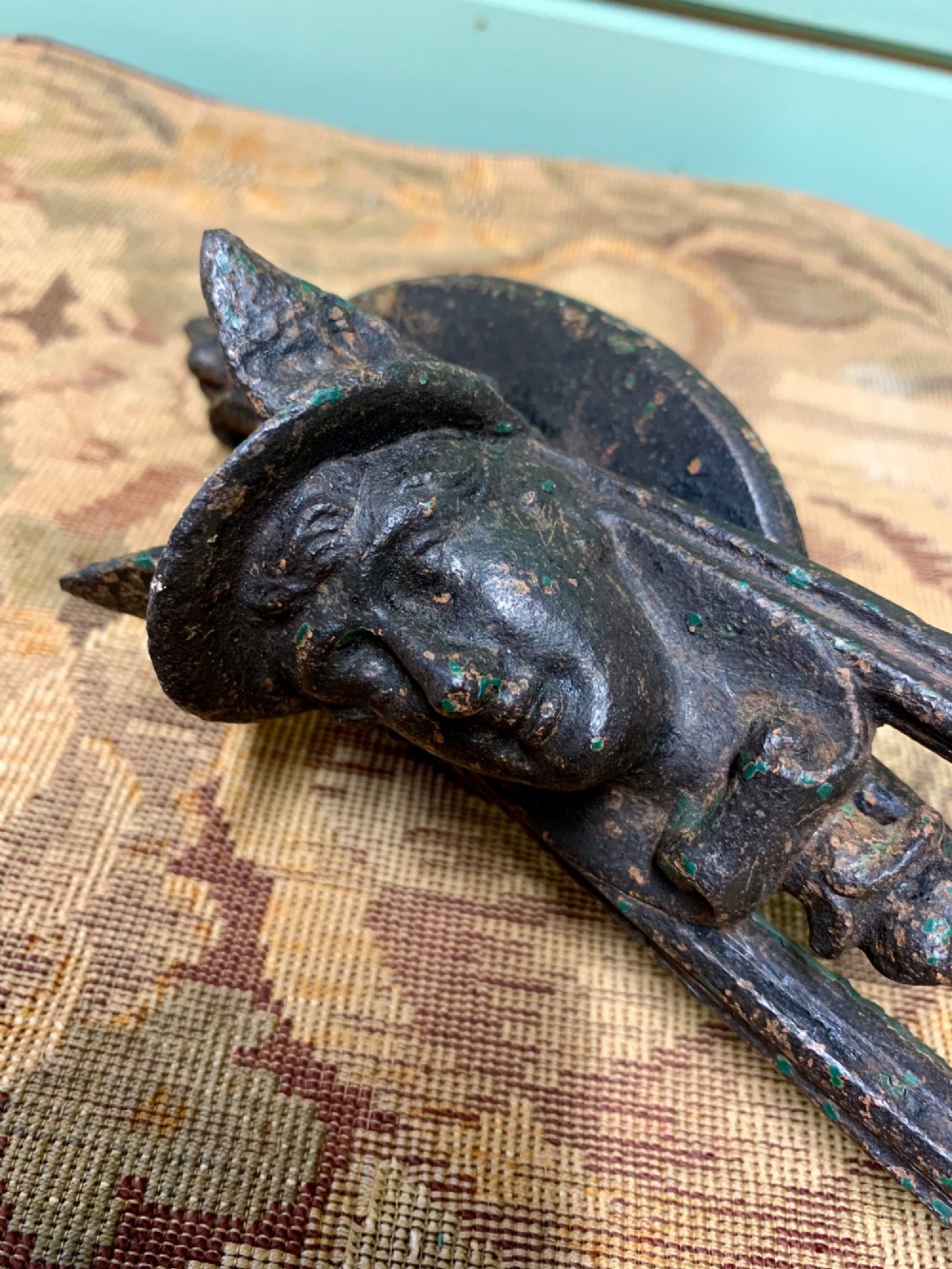 A Victorian cast iron door knocker featuring a sculpted classical Hermes head atop a drop-down loop striker. View VIII