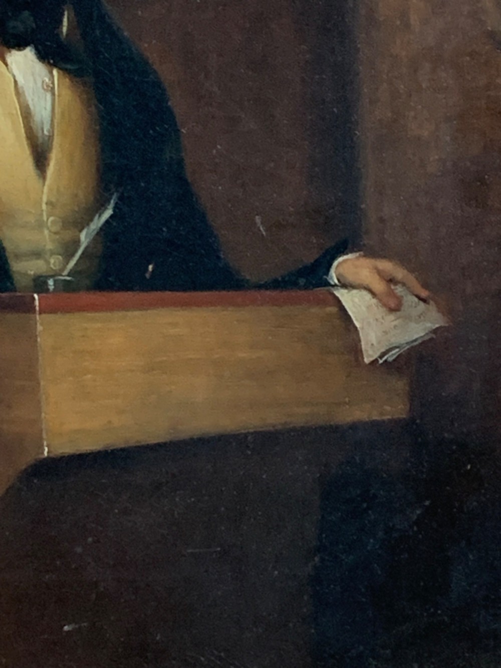 An early 19th-century oil portrait depicting a gentleman at a podium holding a small mallet, housed within a gold leaf frame. View V