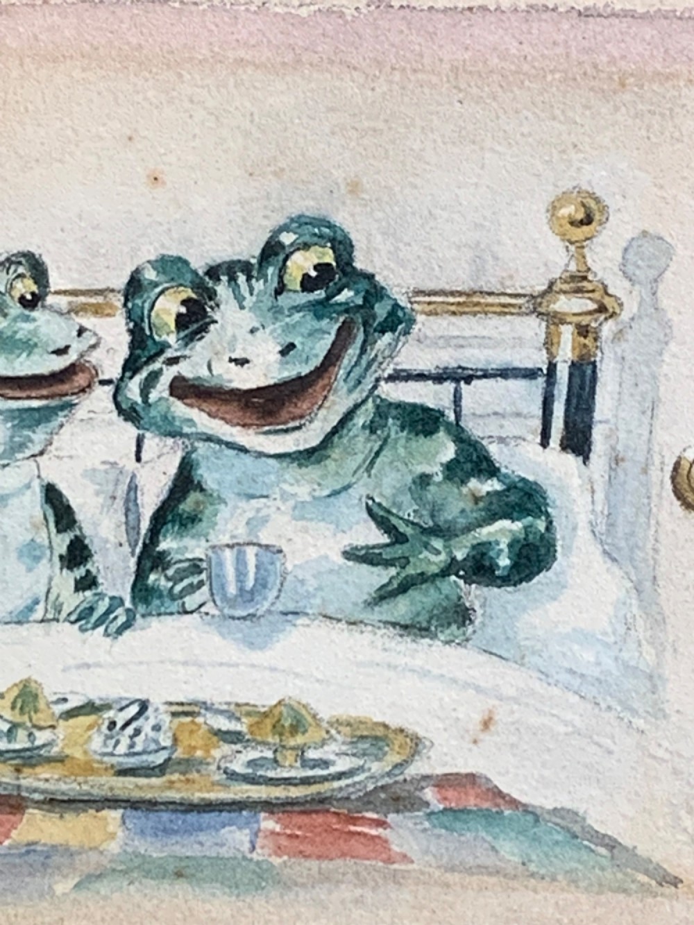 A framed Victorian watercolour painting depicting two anthropomorphic green frogs sitting in a brass bed and drinking tea. View III