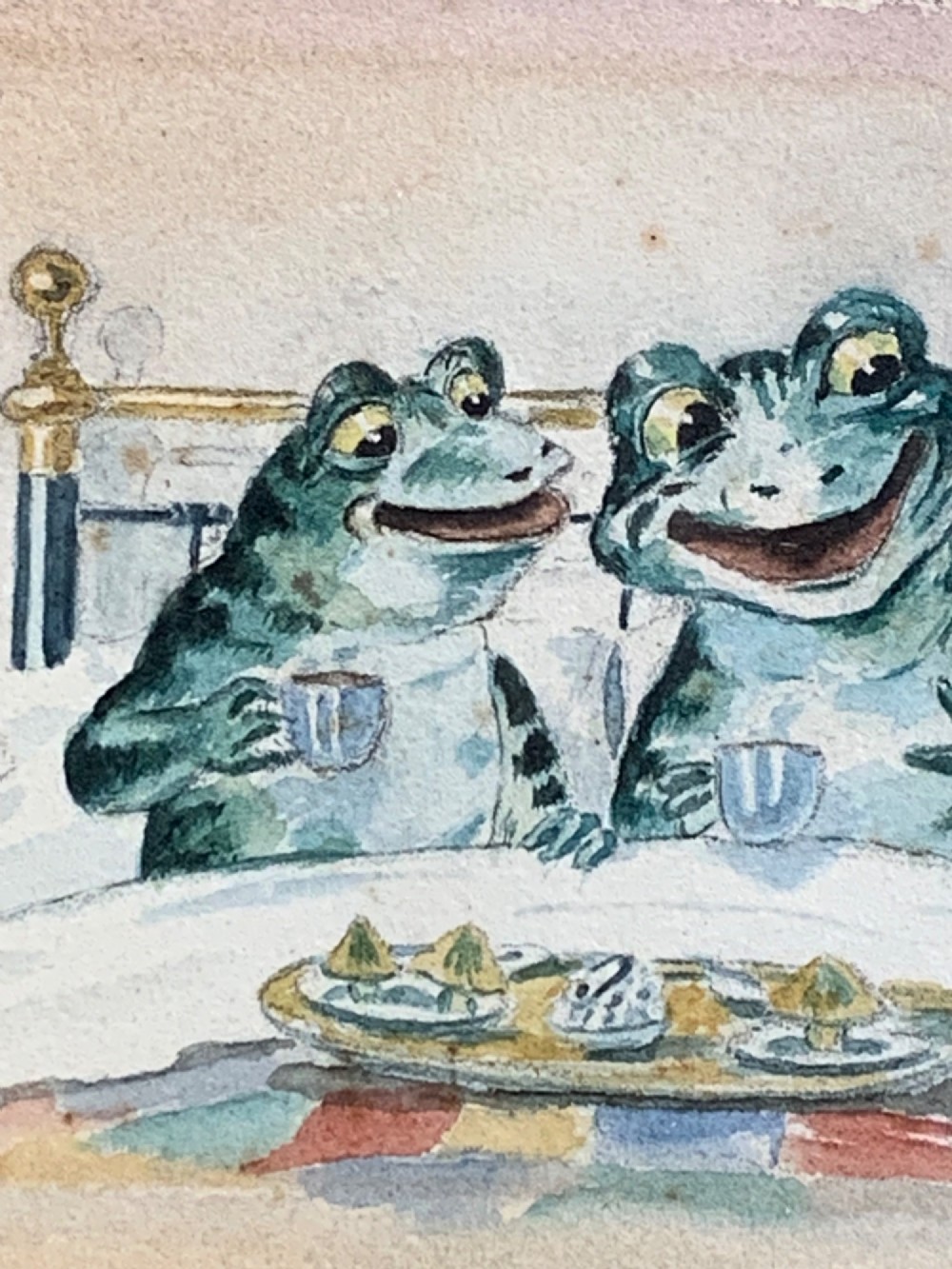A framed Victorian watercolour painting depicting two anthropomorphic green frogs sitting in a brass bed and drinking tea. View IV