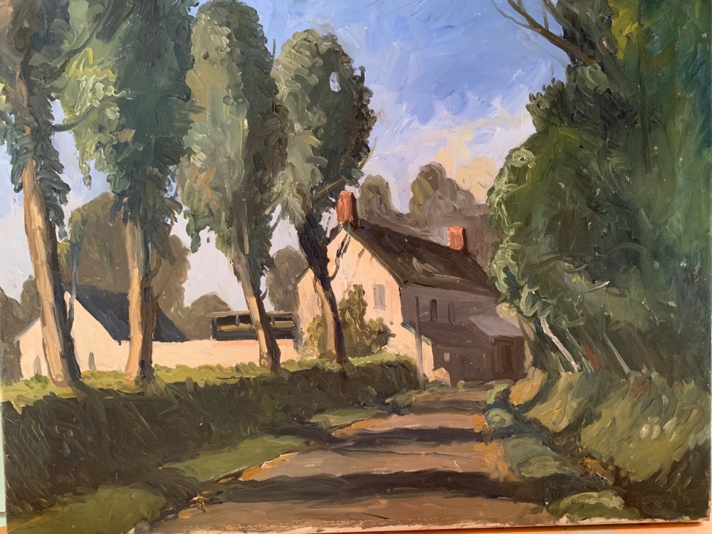 An early twentieth-century French oil painting depicting a sunlit country lane leading past tall trees towards a white farmhouse with terracotta chimneys under a light blue sky.