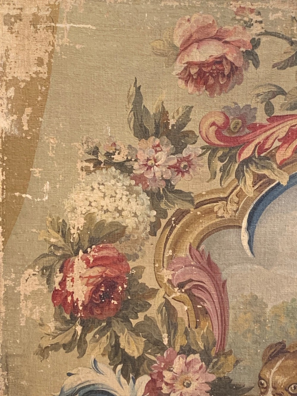 An early 19th-century oil painting on canvas featuring a brown dog framed by a floral cartouche against a muted sage green background. View III