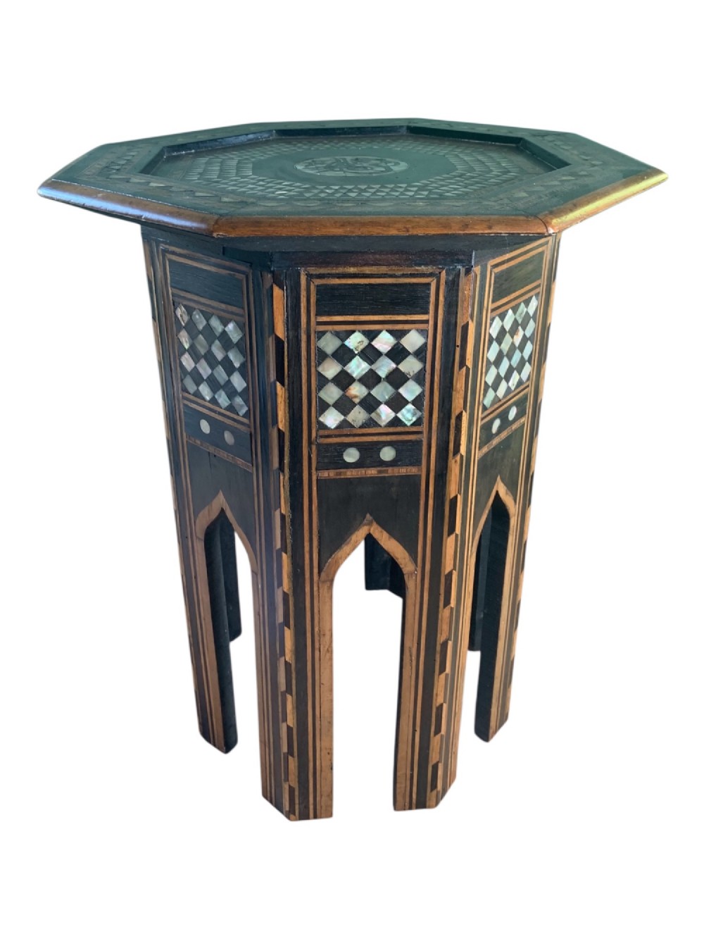 An early 20th-century octagonal Moorish side table made of dark wood with geometric mother-of-pearl inlay and pointed arch legs. View III