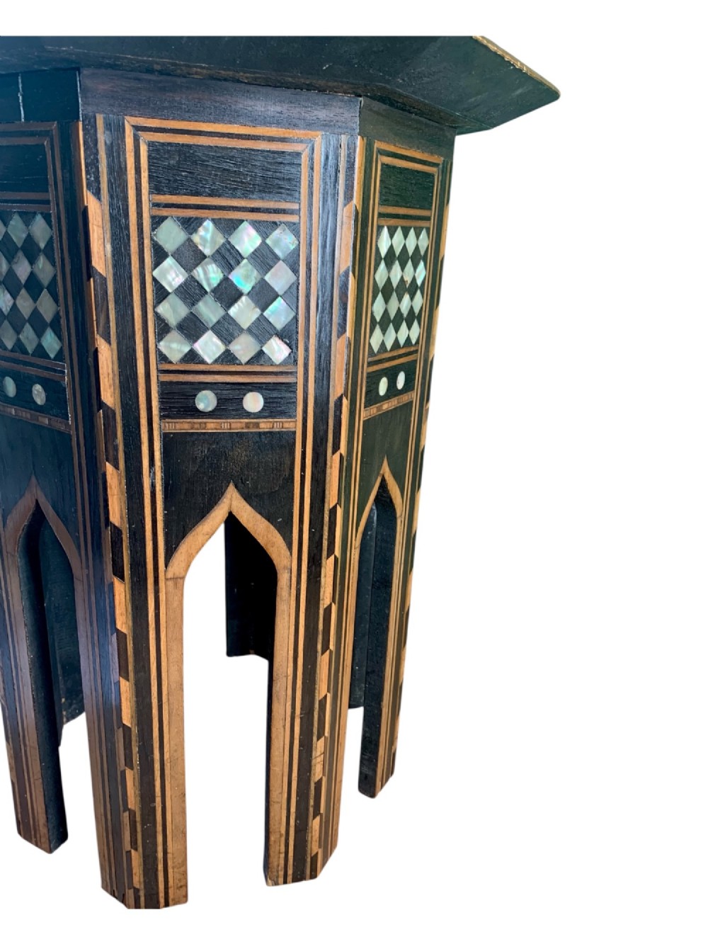 An early 20th-century octagonal Moorish side table made of dark wood with geometric mother-of-pearl inlay and pointed arch legs. View IV